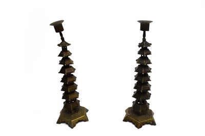 Lot 202 - A pair of Oriental brass candlesticks