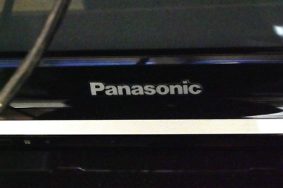 Lot 19 - A Panasonic 50inch television and remote with modern television stand