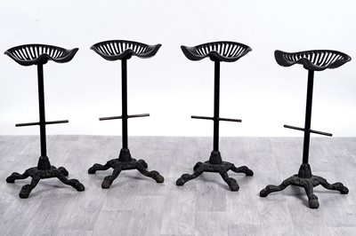 Lot 8 - A set of four vintage cast metal 'Tractor Seat' bar stools/seats