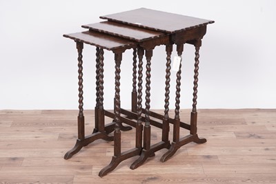 Lot 27 - An early 20th Century oak nest of three tables