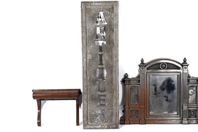 Lot 136 - A Victorian mahogany clock bracket; a wood and tin ‘Antiques’ sign; and another item