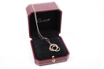 Lot 1302 - Cartier: a pink-sapphire and 18ct yellow gold 'Trinity' pendant