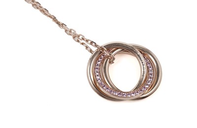 Lot 1302 - Cartier: a pink-sapphire and 18ct yellow gold 'Trinity' pendant