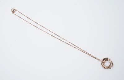 Lot 1302 - Cartier: a pink-sapphire and 18ct yellow gold 'Trinity' pendant