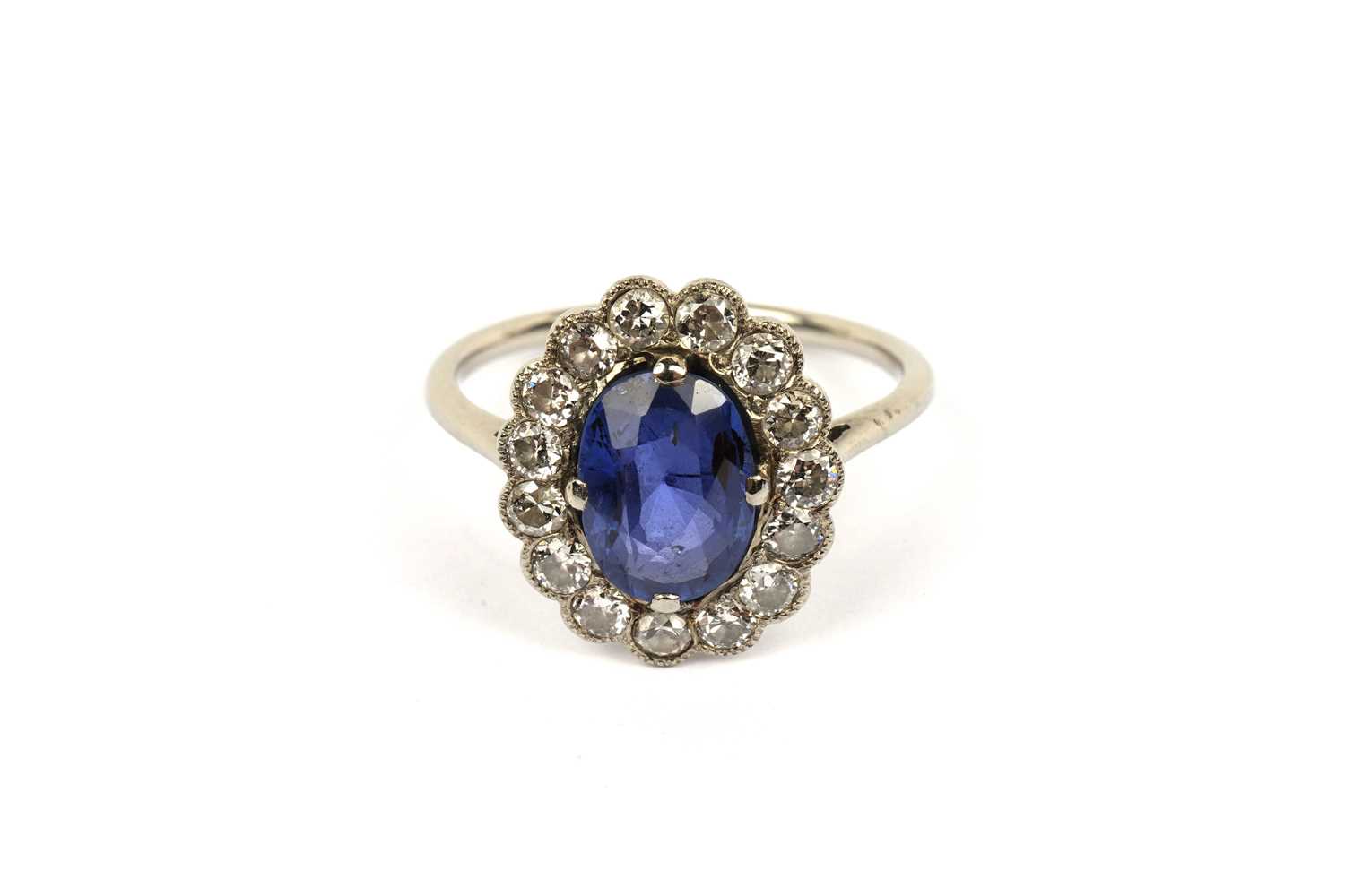 Lot 594 - A sapphire and diamond cluster ring