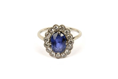 Lot 594 - A sapphire and diamond cluster ring