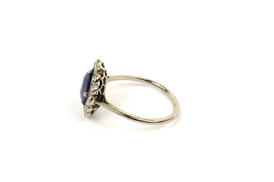 Lot 594 - A sapphire and diamond cluster ring