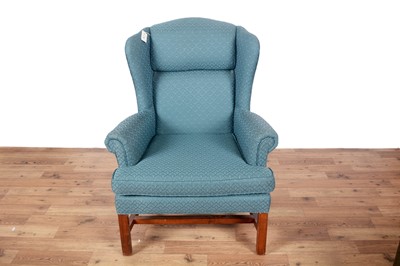 Lot 89 - A Georgian style wingback armchair; and a mid-20th Century oak framed ottoman