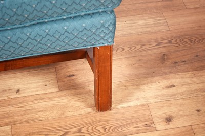 Lot 89 - A Georgian style wingback armchair; and a mid-20th Century oak framed ottoman