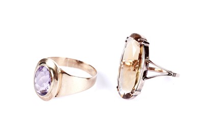 Lot 58 - A single stone amethyst dress ring; and a smoky quartz dress ring