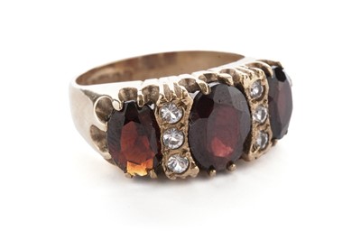 Lot 15 - A garnet and white stone dress ring