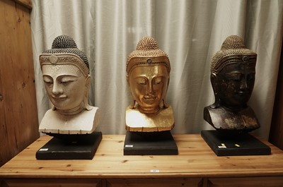 Lot 380 - A set of three decorative wooden Thai Buddha busts