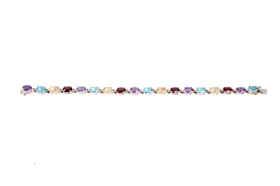 Lot 66 - A peridot, topaz, citrine and garnet line bracelet