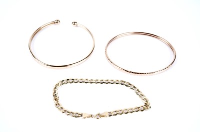 Lot 224 - Two gold bangles; and a gold bracelet