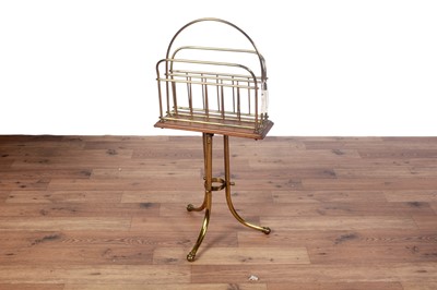 Lot 1 - A early 20th Century brass and oak revolving magazine rack