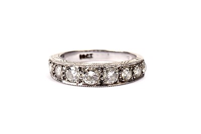 Lot 664 - A nine stone diamond half eternity ring