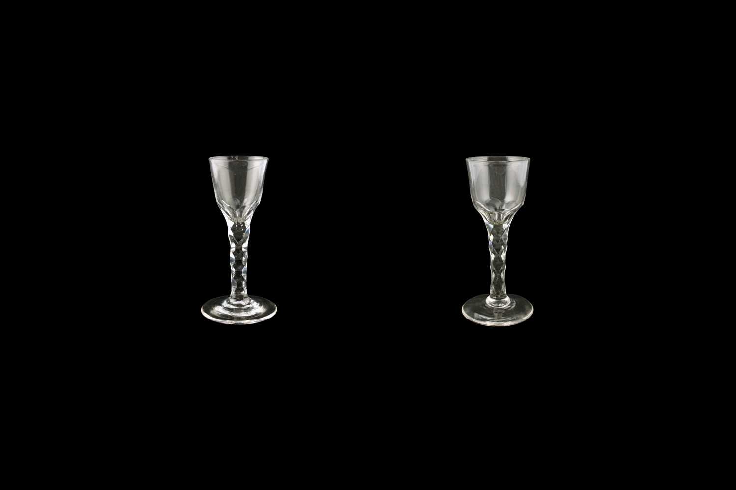 Lot 70 - Two George III wine glasses with facetted stems