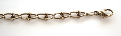 Lot 28 - A bi-colour yellow and white gold fancy link chain bracelet