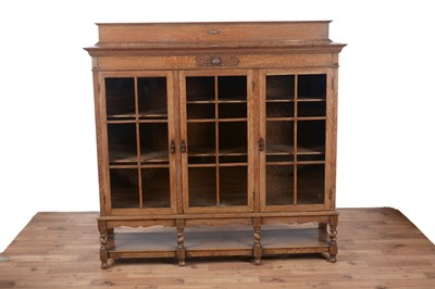 Lot 84 - An early 20th Century carved oak bookcase