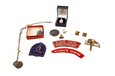 Lot 938 - A selection of military interest items including: a silver Air Raid Patrol lapel badge