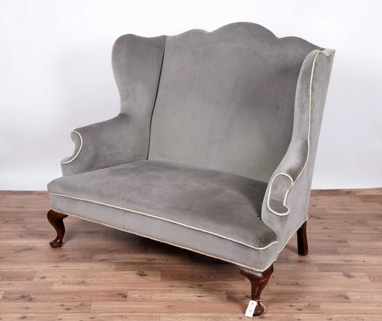 Lot 110 - A late 19th Century wingback sofa