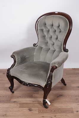 Lot 138 - A Victorian carved mahogany balloon and button back armchair