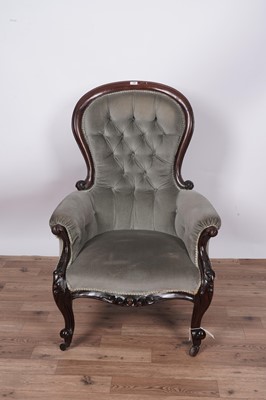 Lot 138 - A Victorian carved mahogany balloon and button back armchair