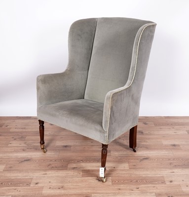 Lot 111 - A Georgian style wingback armchair