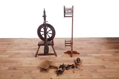 Lot 52 - A late 19th Century stained hardwood spinning wheel, wool winder and accessories