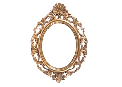 Lot 395 - A Victorian oval carved giltwood mirror