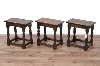 Lot 41 - A set of three Jacobean style set of three oak stools