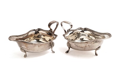 Lot 277 - A pair of George V silver sauce boats by Reid & Sons