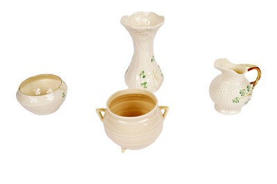 Lot 324 - A Belleek shamrock pattern cream jug, sugar bowl and vase; and sugar bowl