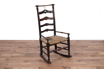 Lot 111 - A 19th Century oak ladderback elbow rocking chair