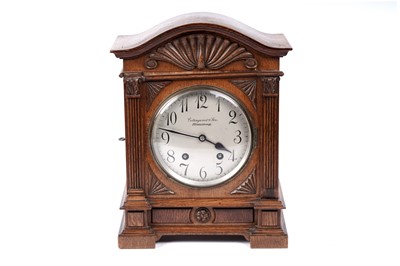 Lot 213 - An early 20th Century German carved oak mantel clock