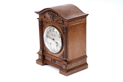 Lot 213 - An early 20th Century German carved oak mantel clock