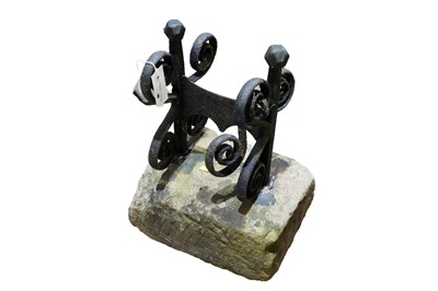 Lot 496 - A cast iron boot scraper on rectangular stone base