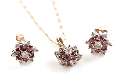 Lot 123 - A diamond and ruby cluster pendant; and matching stud earrings