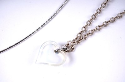 Lot 196 - A Lalique opalescent glass heart pendant; and an amethyst pendant necklace