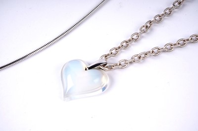 Lot 196 - A Lalique opalescent glass heart pendant; and an amethyst pendant necklace
