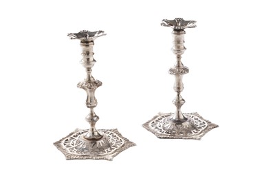 Lot 148 - A pair of late Victorian cast silver tapersticks