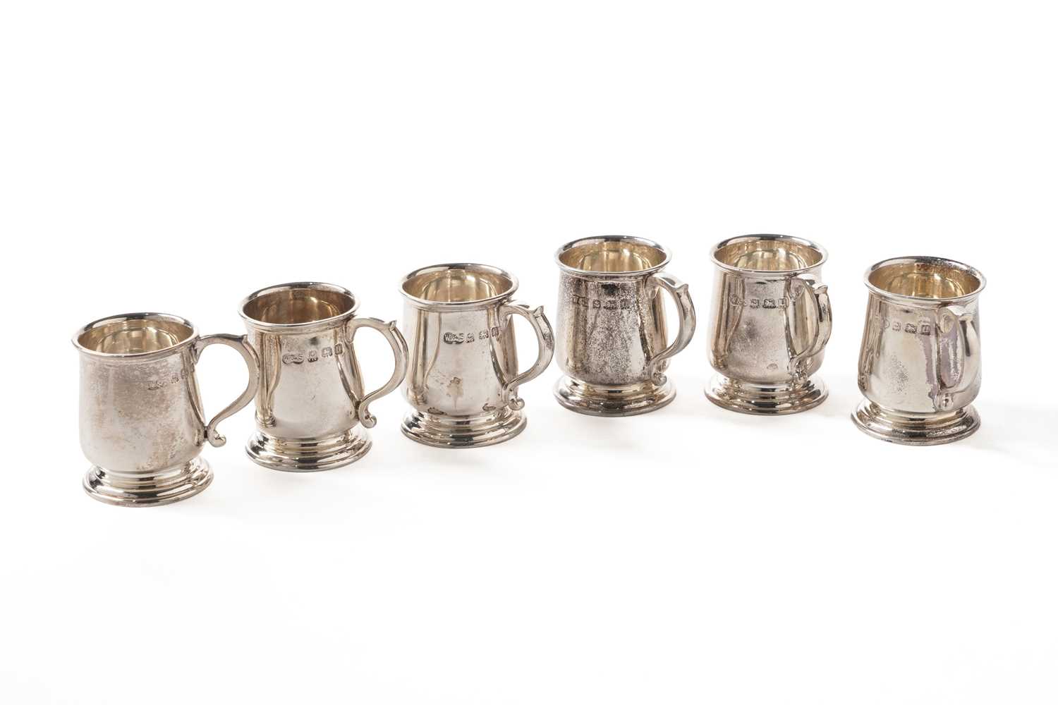 Lot 160 - A George V cased set of six silver tot cups in the form of miniature mugs