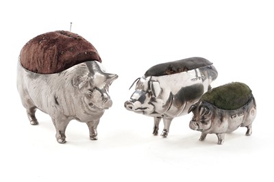 Lot 370 - An Edwardian silver pin cushion in the form of a pig; and two others