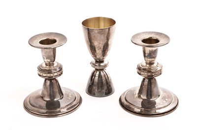 Lot 263 - A pair of Lindisfarne silver candlesticks by Reid & Sons; and a Lindisfarne silver measure