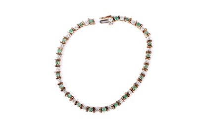 Lot 143 - An emerald and diamond tennis bracelet