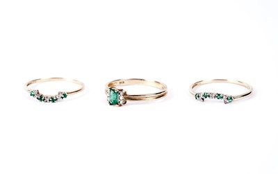 Lot 171 - An emerald and diamond ring trio