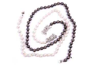 Lot 611 - A pair of black and white South Sea cultured pearl necklaces with diamond clasps