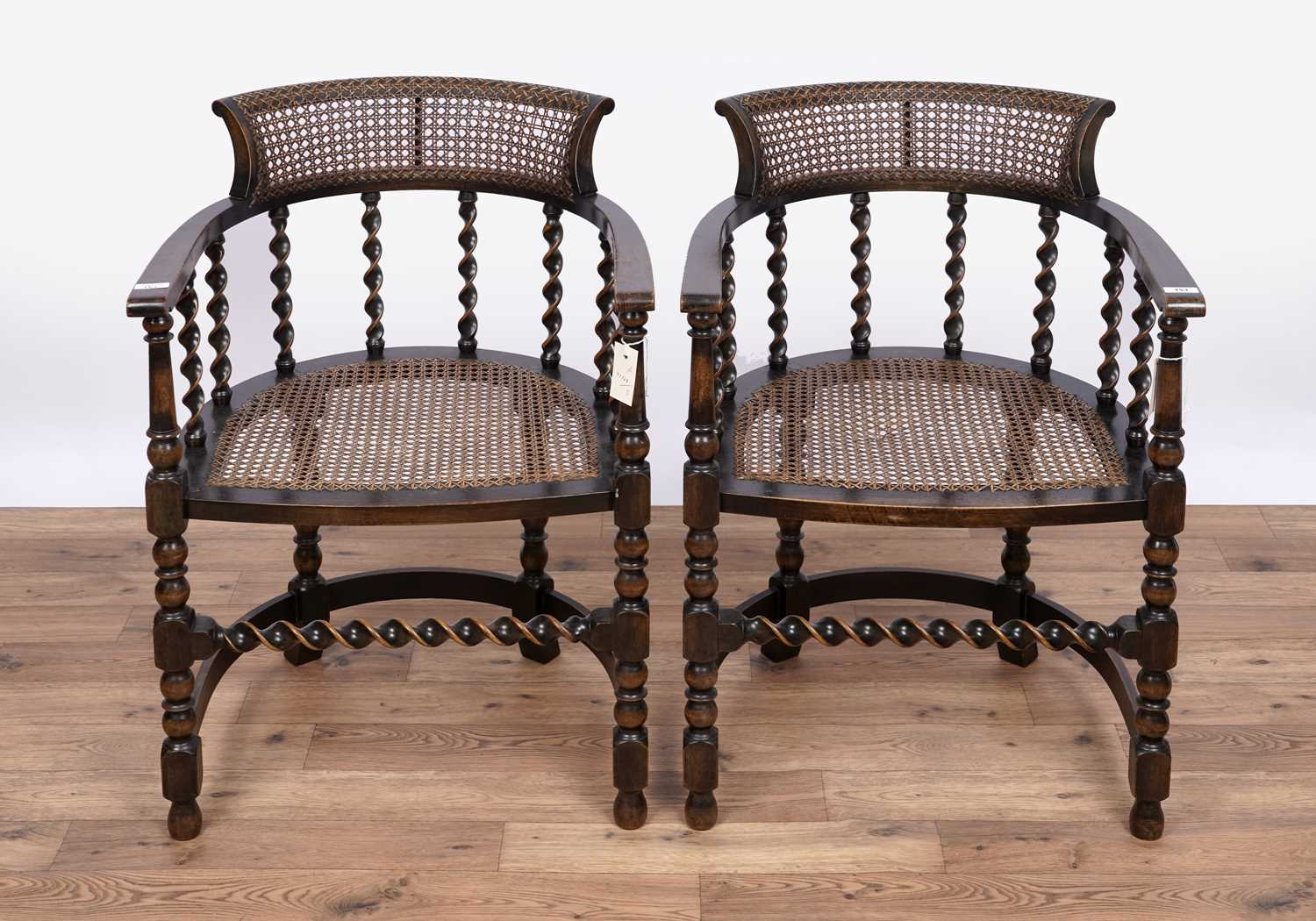 Lot 151 - A pair of early 20th Century stained beech and canework armchairs