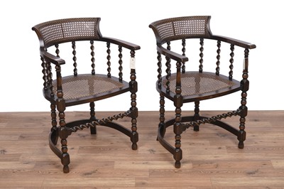 Lot 151 - A pair of early 20th Century stained beech and canework armchairs