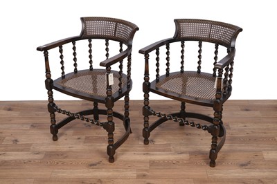 Lot 151 - A pair of early 20th Century stained beech and canework armchairs